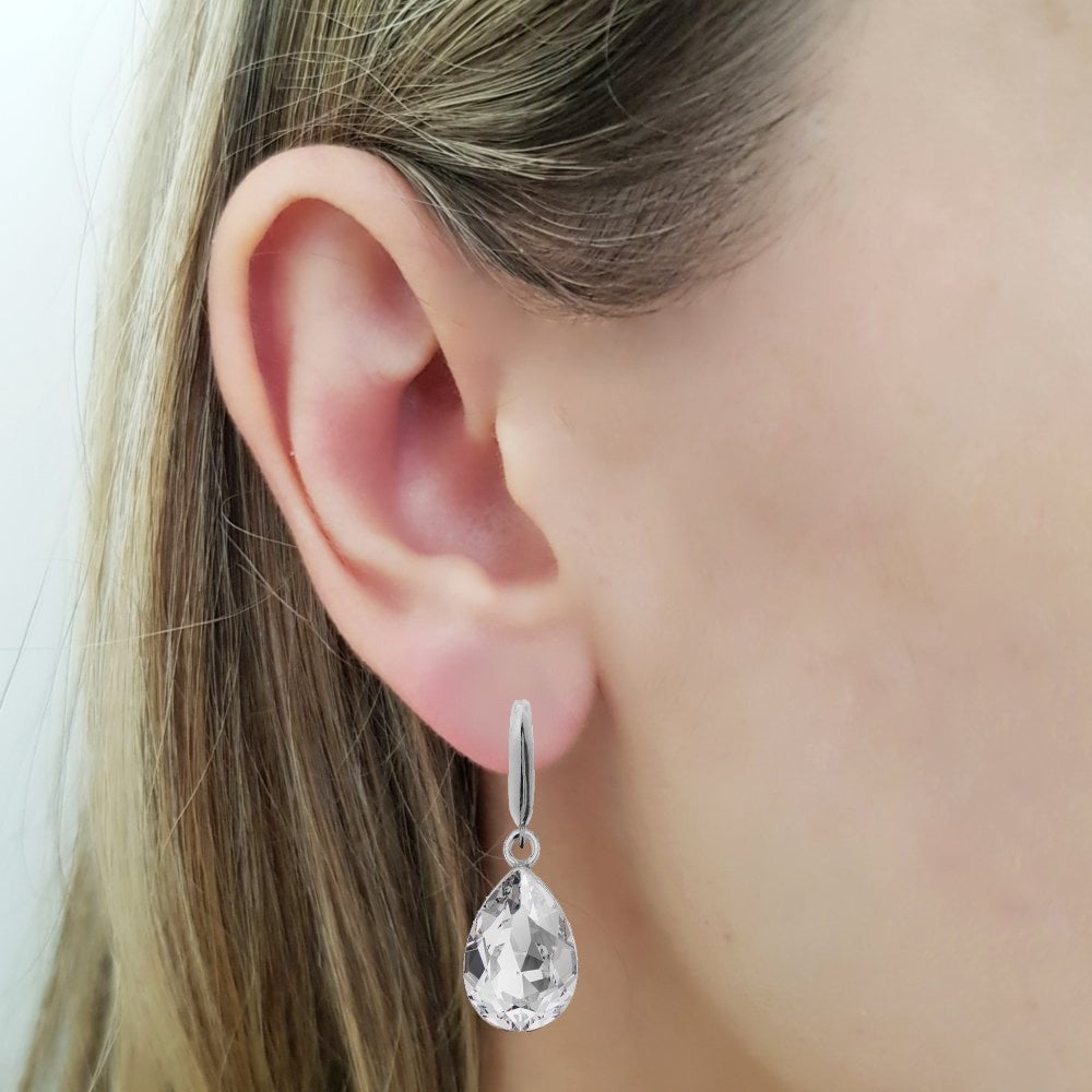 Woman wearing a Dangling Pear-Cut Drop Earrings in Sterling Silver with Crystal Clear Teardrop Austrian Crystals