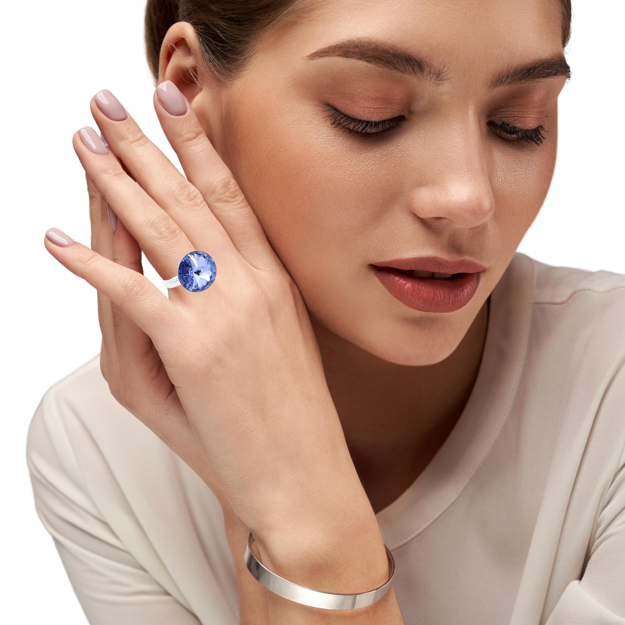 Elegant hand adorned with the Spectra Solitaire Ring, showcasing the brilliant Tanzanite Purple Rivoli Crystal - Magpie Gems Ireland