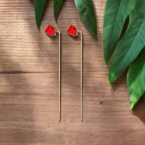 A pair of 925 sterling silver ear threader earrings with a 6mm siam red crystal cube, made in Ireland by Magpie Gems Jewellery