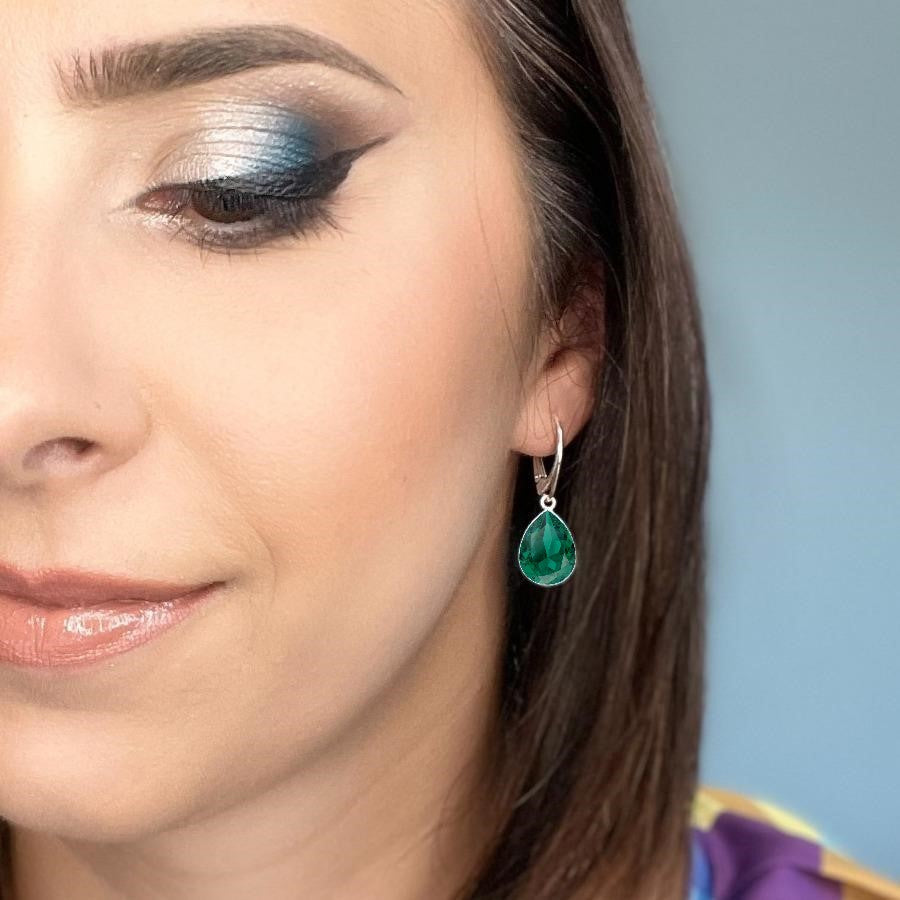 Woman wearing Sterling Silver Teardrop Earrings with Emerald Green Pear-Cut Crystals from Austria, made by Magpie Gems in Ireland