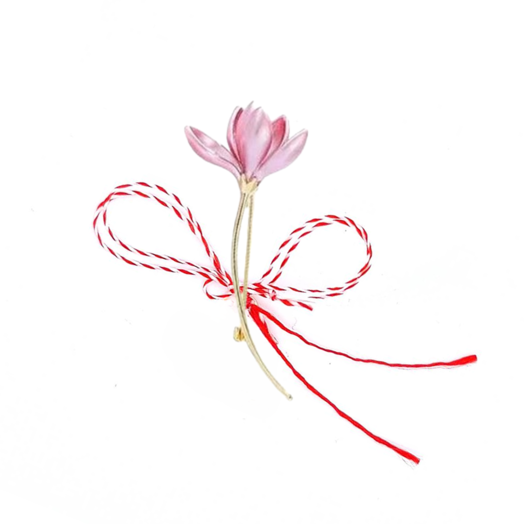 Pink Crocus Martisor Brooch on a white background, featuring delicate pink petals and a golden stem, symbolising spring and renewal, accompanied by the traditional Martisor red and white bow.