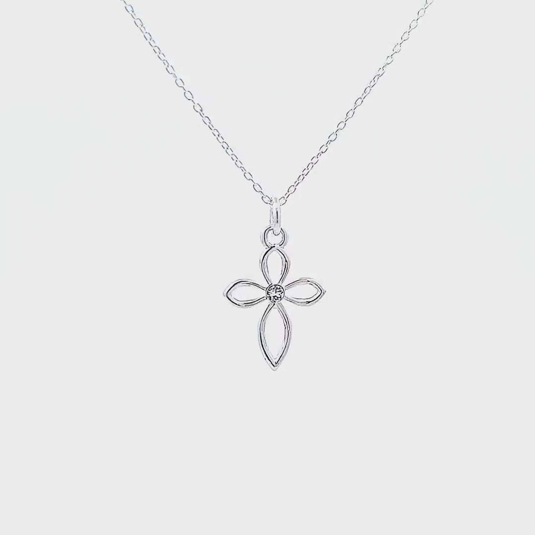 Video showcasing the Divine Grace Silver Cross Necklace on a white background. Highlights the reflective quality of the silver and crystal as the cross necklace  moves.