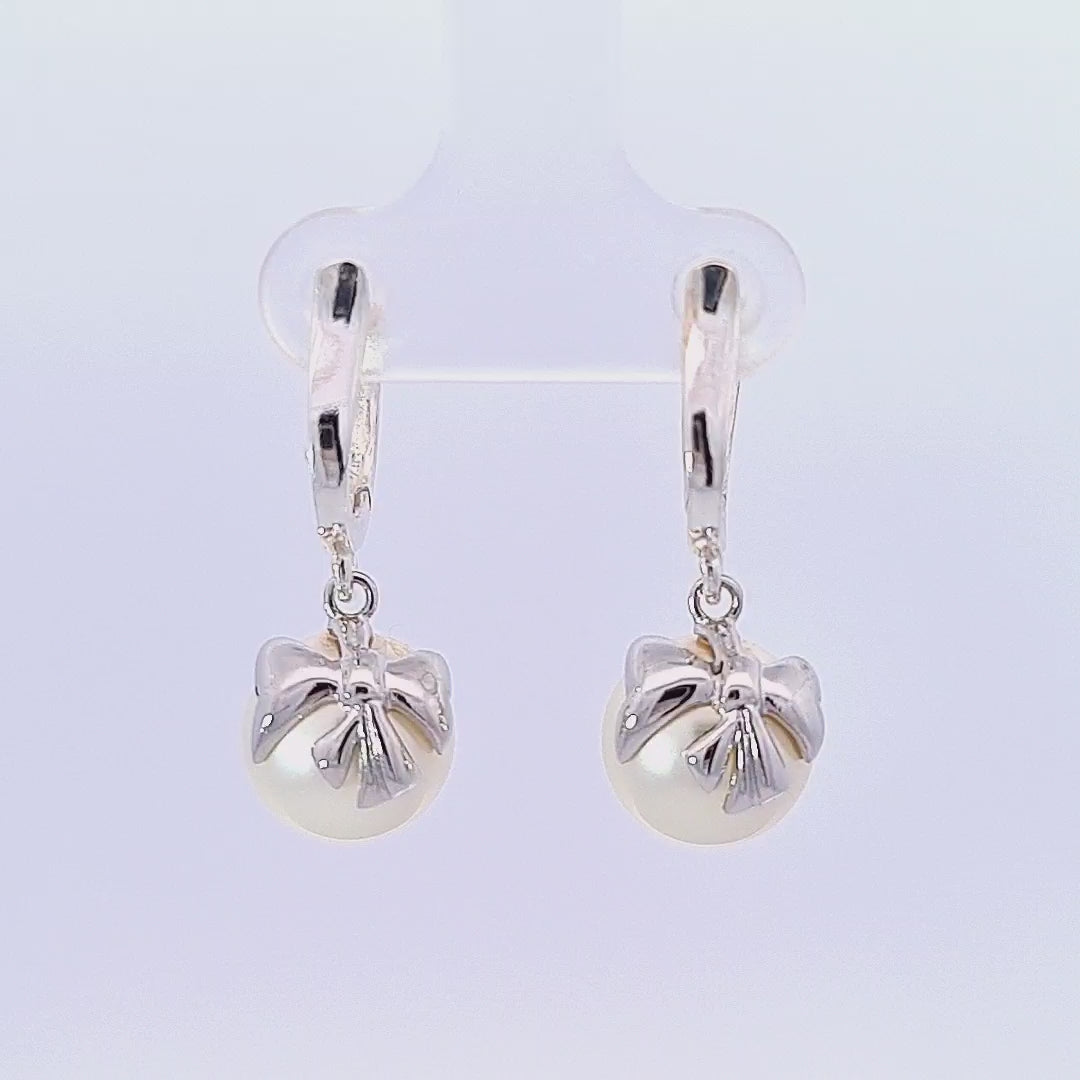 Video of the Silver Bow Pearl Drop Huggie Earrings for Women