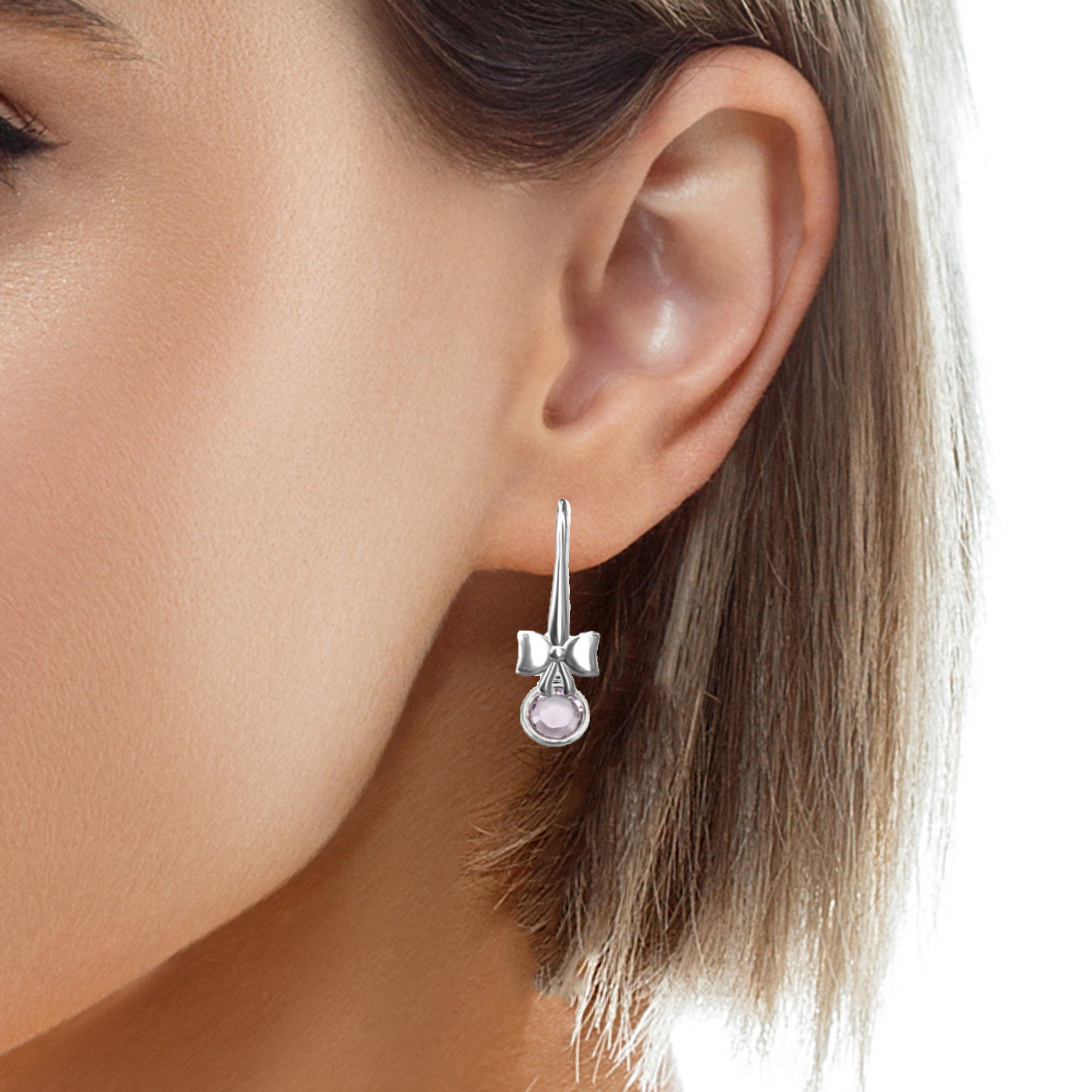 Woman Wearing Magpie Gems' Silver Bow and June Birthstone Drop Earrings in Sterling Silver with Austrian Crystals Light Amethyst