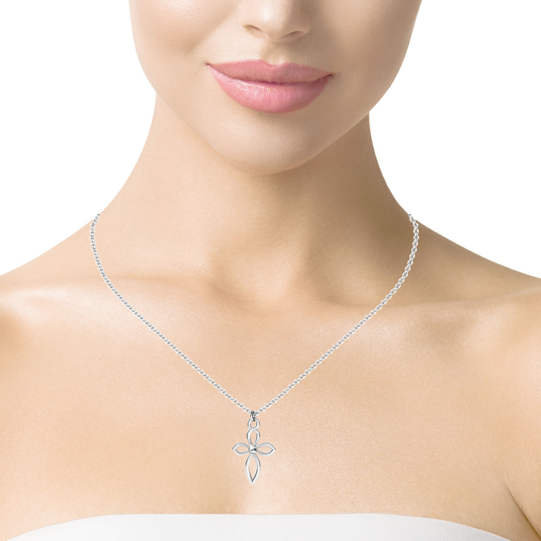 Model wearing the Divine Grace Silver Cross Necklace, showcasing how it elegantly rests against the breastbone.