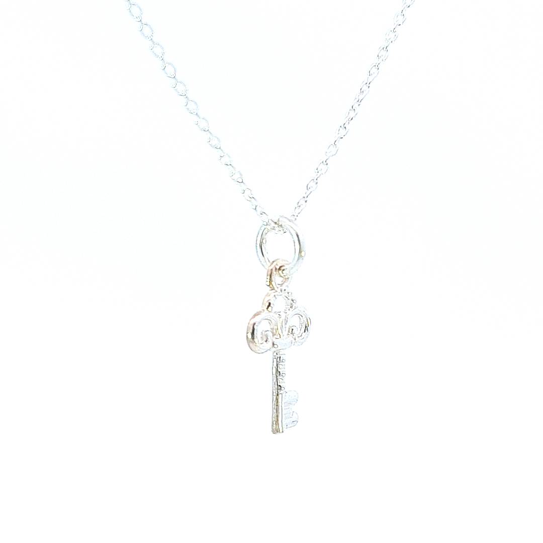 A small silver pendant necklace with a small key pendant, made in Ireland