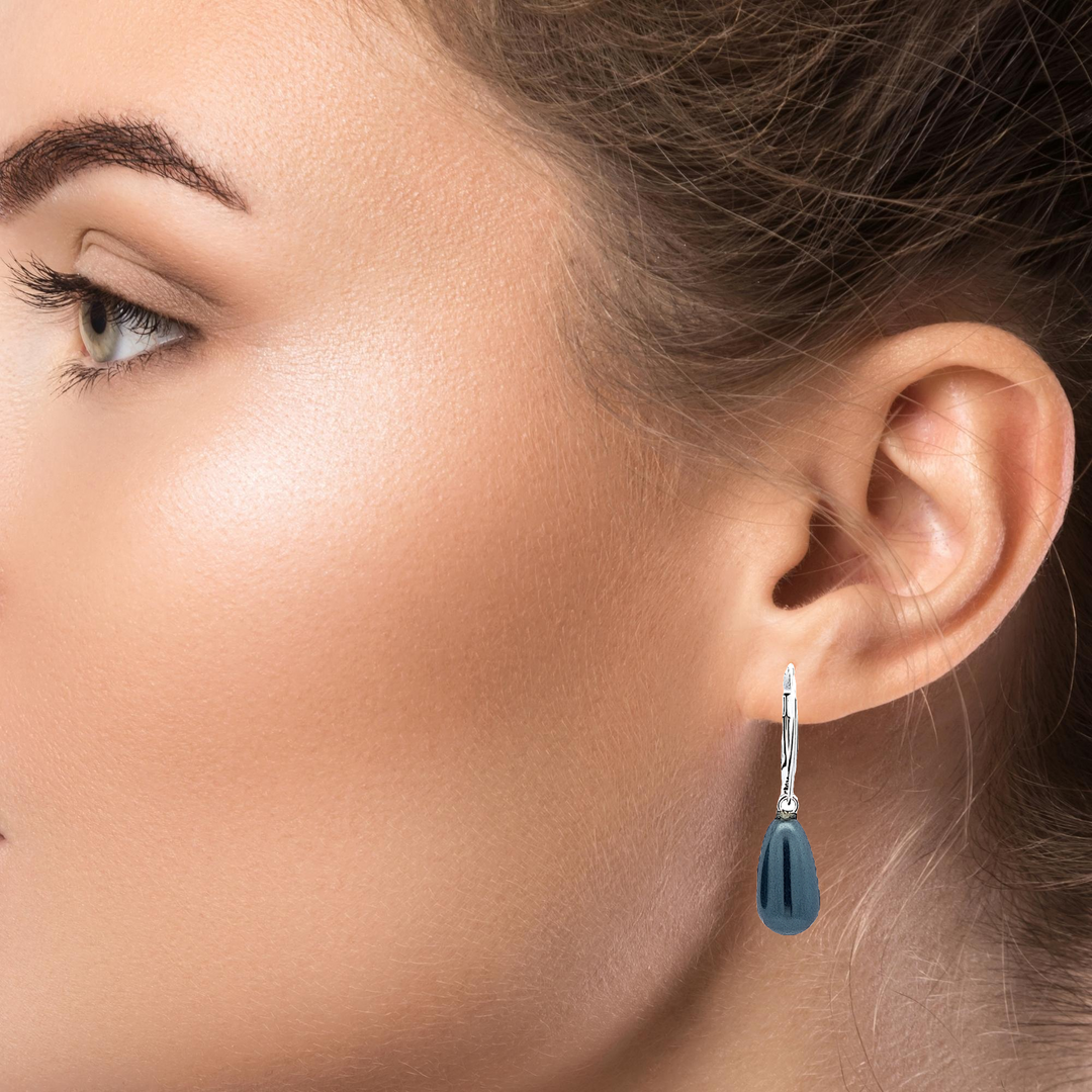 A close-up view of  women wearing Austrian crystal pearls adorning the silver drop earrings. The Tahitian Pearl Crystals add a subtle sparkle and enhance the overall beauty.