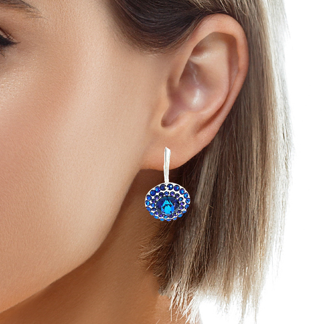 Woman wearing the Dazzling Daisy Heliotrope Pave Drop Earrings in Sterling Silver