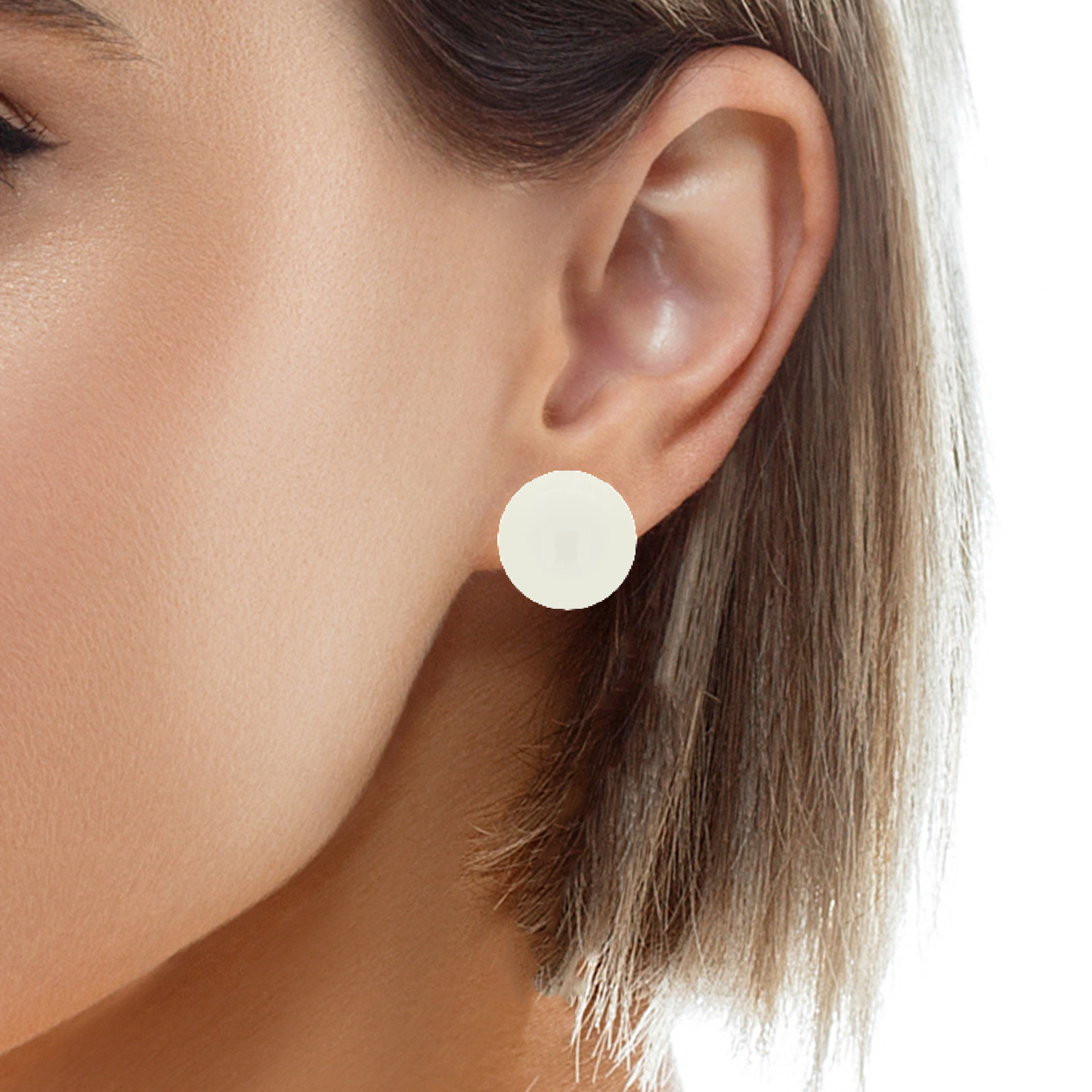 Woman wearing 16mm ivory pearl clip-on earrings in sterling silver, demonstrating the elegant look on non-pierced ears