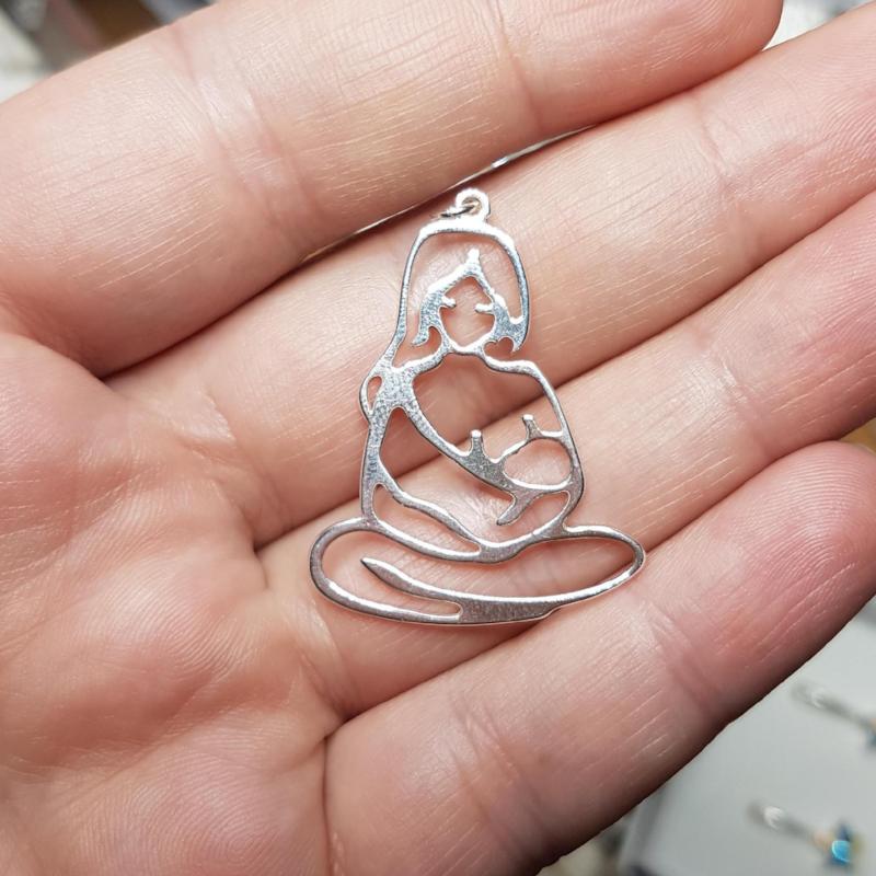 Close-up of Mother breastfeeding a Baby or Child Pendant in Sterling Silver worn by Alba Padro Arochas from Lactapp and author of Somos la laeche