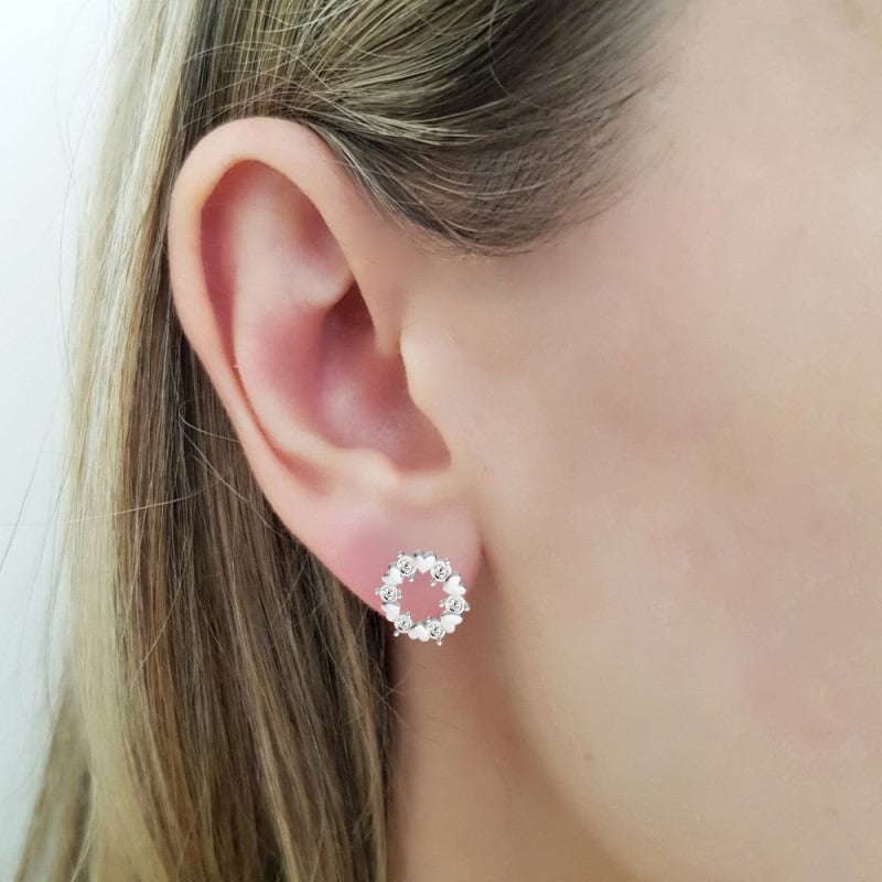 Woman Wearing Elegant Sterling Silver Earrings with Heart and Crystal Design, by Magpie Gems in Ireland