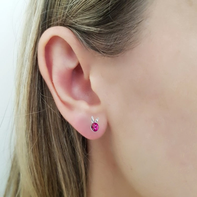 Model showcasing the playful Sterling Silver Bunny Stud Earrings with fuchsia pink crystals and bunny ears design for girls and women, by Magpie Gems Ireland.