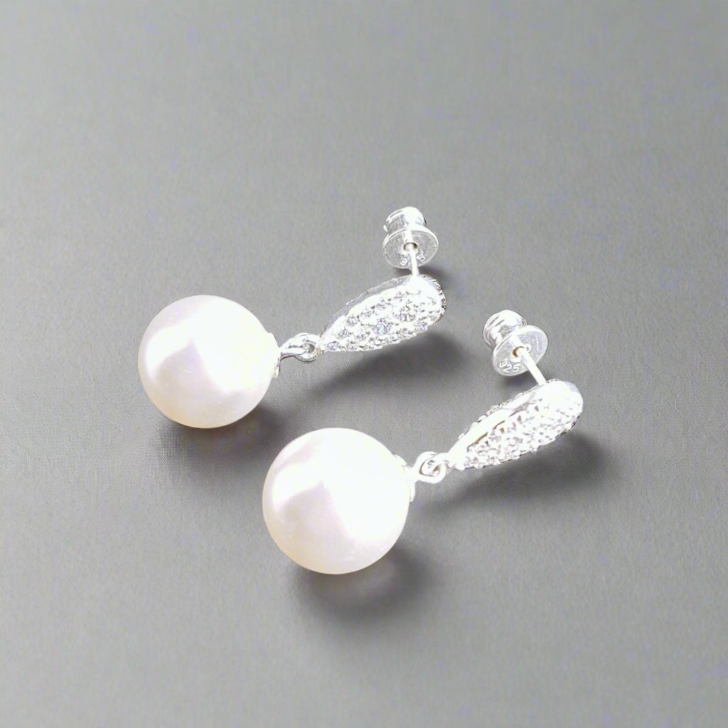 Wlegant Pearl Drop Earring in Sterling Silver featuring a 12mm white pearl and Austrian crystal pavé teardrop design, handmade in Ireland by Magpie Gems