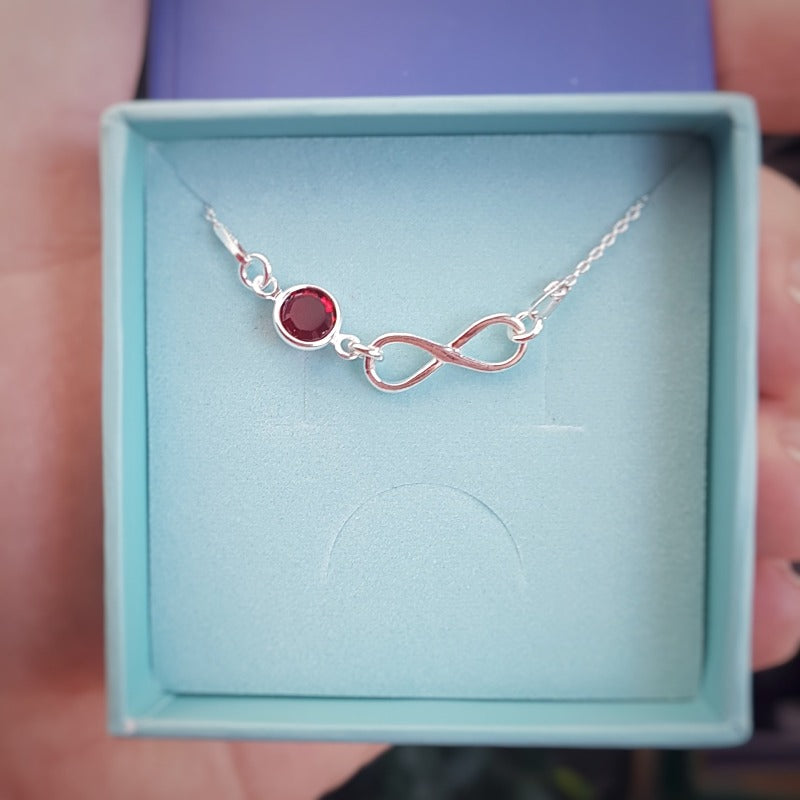 Personalised silver infinity with birthstone crystal pendant necklace for women, with a ruby birthstone for July