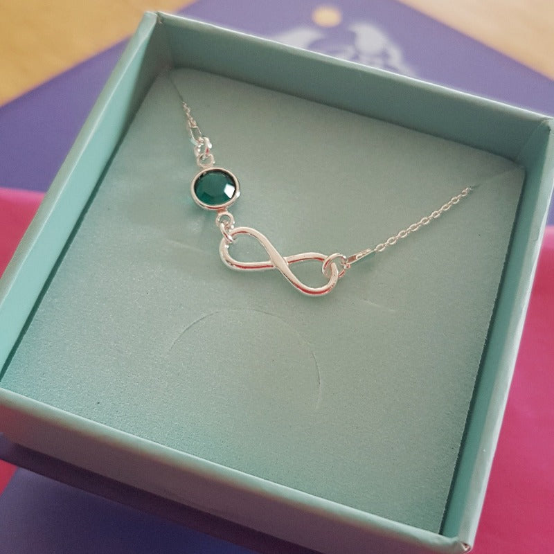 Custom made silver infinity with birthstone crystal pendant necklace for women, with an emerald green birthstone for May