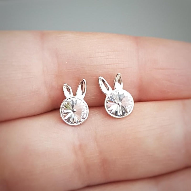 Close-up of girls' Sterling Silver Bunny Stud Earrings showcasing the playful bunny ears design and clear crystal, by Magpie Gems in Ireland.