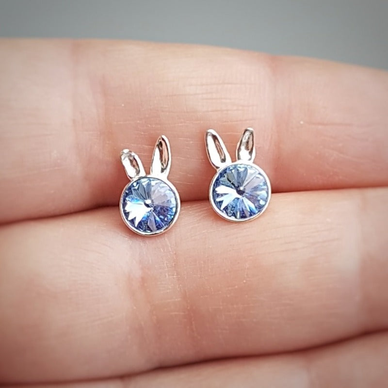 Close-up of Sterling Silver Bunny Stud Earrings showcasing the playful bunny ears design and light sapphire blue crystal for girls.