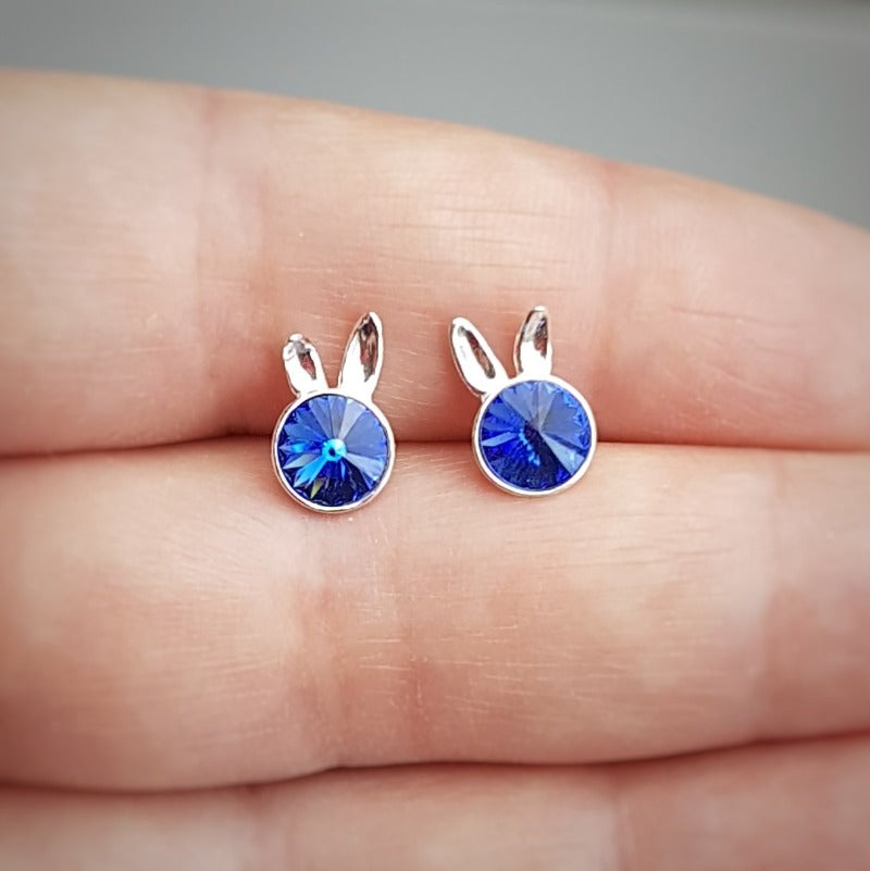 Close-up of Sterling Silver Bunny Stud Earrings showcasing the playful bunny ears design and sapphire blue crystal.