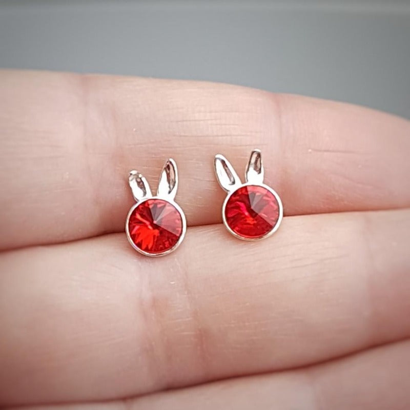 Close-up of Sterling Silver Bunny Stud Earrings showcasing the playful bunny ears design and light siam red crystal for girls.